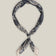 Navy cotton bandana with intricate light paisley motifs and a pale contrasting border, tied as a neck scarf.