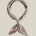 Beige cotton bandana with intricate dark paisley motifs and a muted contrasting border, tied as a neck scarf.