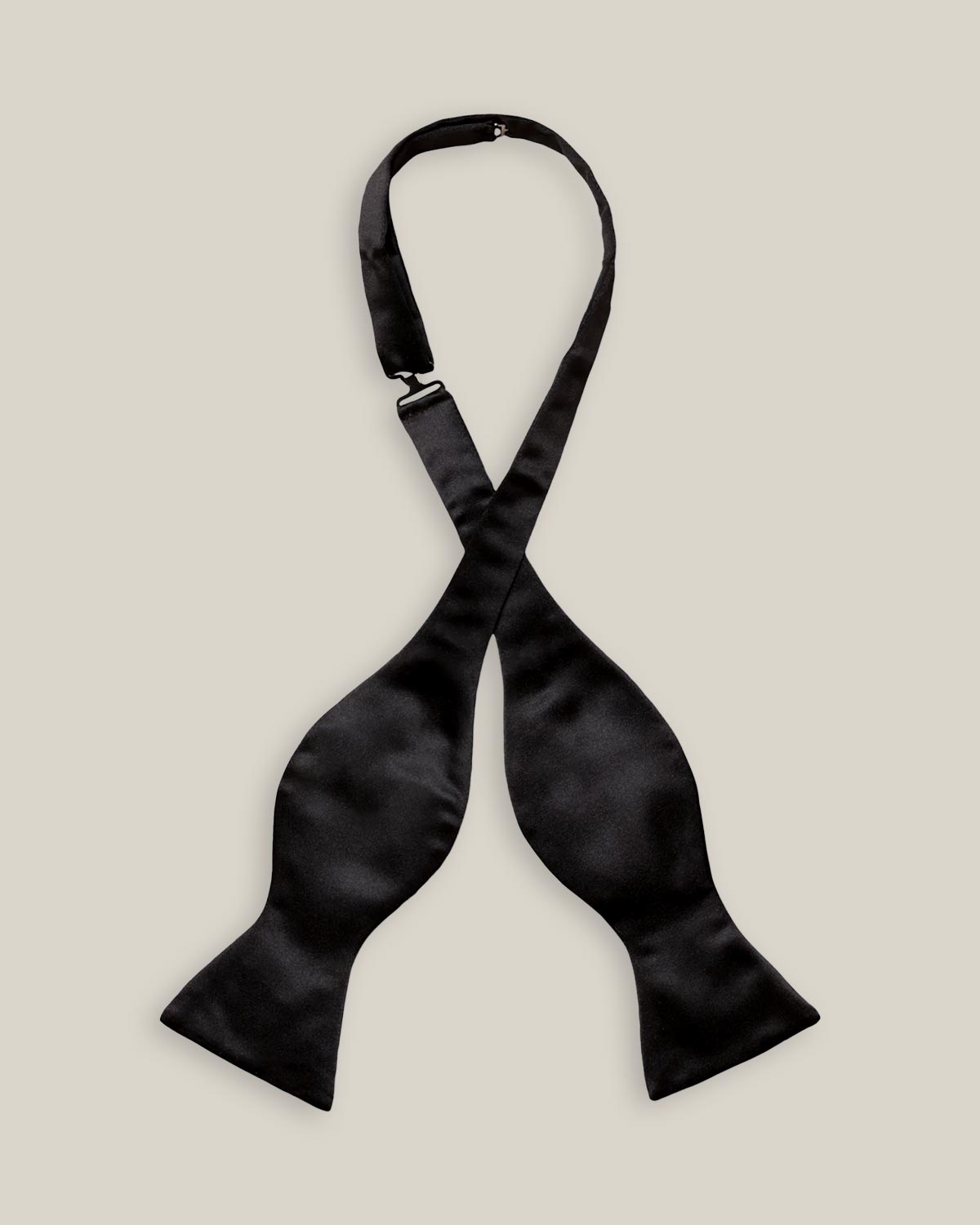 Untied black silk satin bow tie with classic butterfly-shaped ends