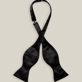 Untied black silk satin bow tie with classic butterfly-shaped ends