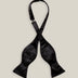 Untied black silk satin bow tie with classic butterfly-shaped ends