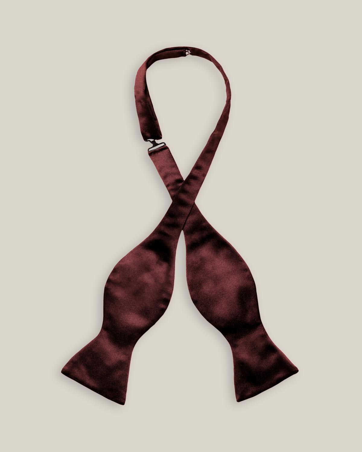 Untied burgundy silk satin bow tie with classic butterfly-shaped ends