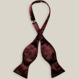 Untied burgundy silk satin bow tie with classic butterfly-shaped ends