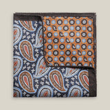 Double-face silk pocket square with deep blue paisley and a copper geometric floral reverse, featuring pale blue, brown, red and ivory details.