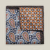 Double-face silk pocket square with deep blue paisley and a copper geometric floral reverse, featuring pale blue, brown, red and ivory details.