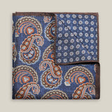 Navy double-face silk pocket square with ornate brown, orange and ivory paisley, a small floral medallion reverse and a brown border.