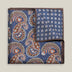 Navy double-face silk pocket square with ornate brown, orange and ivory paisley, a small floral medallion reverse and a brown border.