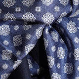 Close-up of the navy silk scarf with ivory floral medallions and smaller decorative motifs