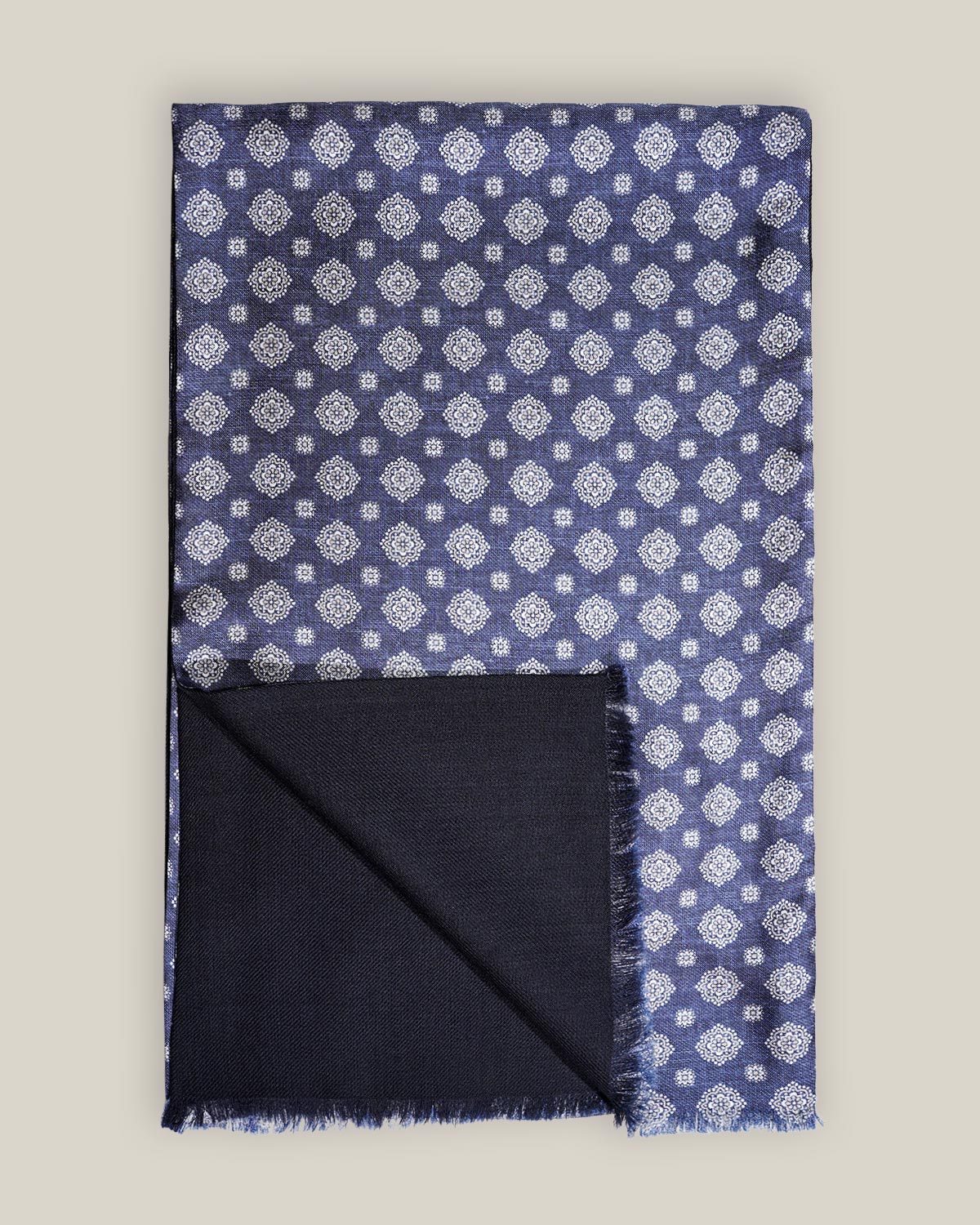 Navy medallion silk scarf with plain navy wool backing and short fringed edges, shown folded