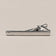 Silver-tone tie clip with a smooth reflective face, curved detail at one end and spring-loaded fastening.