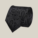 Black paisley 100% silk tie by Stockholm Kravatt, rolled detail view