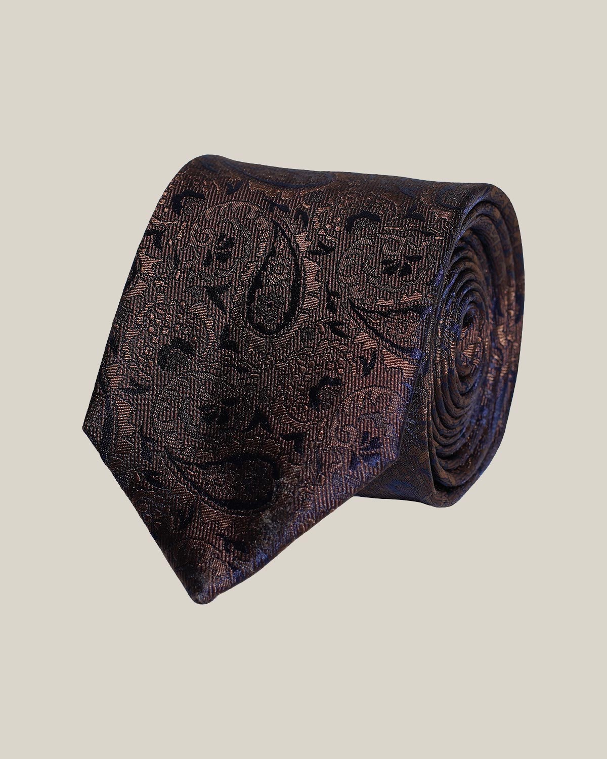 Dark brown paisley 100% silk tie by Stockholm Kravatt, rolled detail view