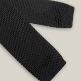 Black knitted tie with a textured surface and classic straight square end