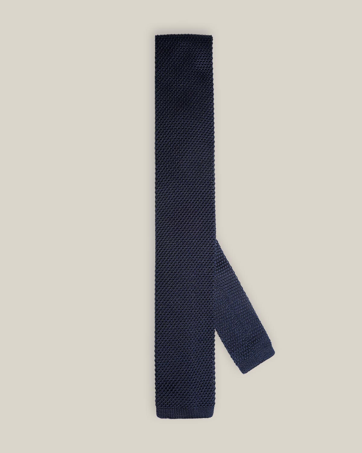 Navy knitted tie with a textured surface and classic straight square end