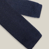 Navy knitted tie with a textured surface and classic straight square end