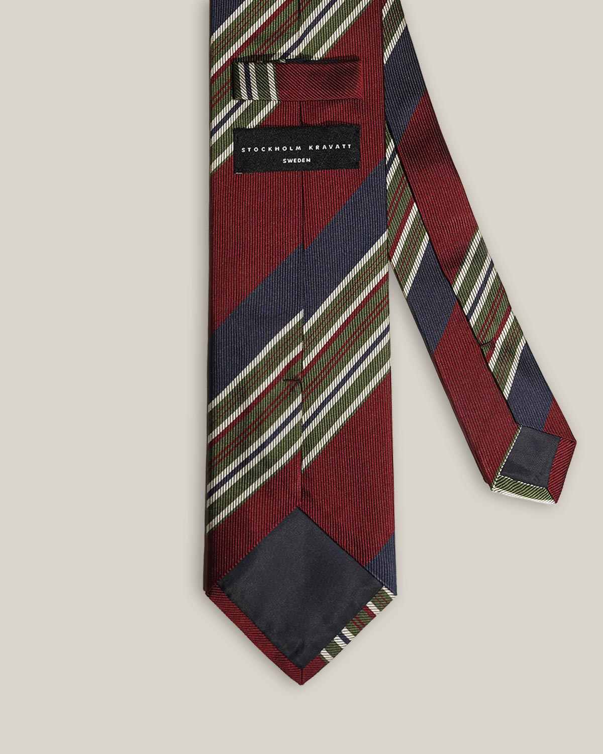 Back detail of striped silk tie with Stockholm Kravatt label and keeper loop