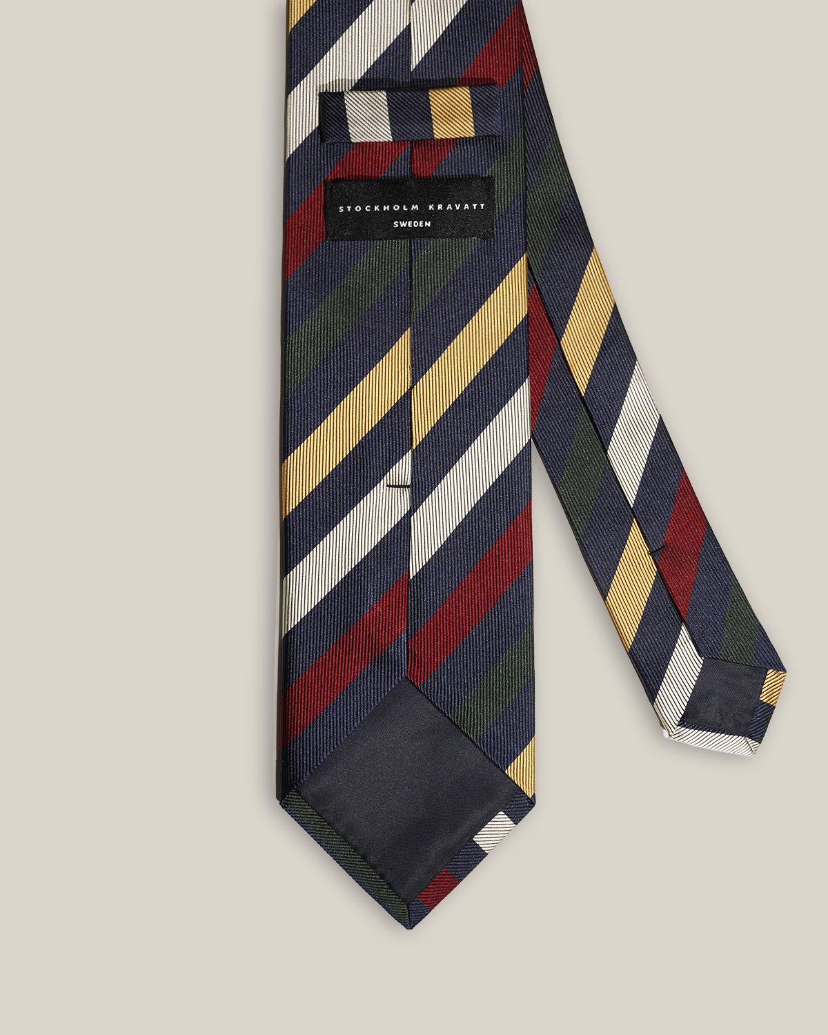 Back detail of navy striped silk tie with Stockholm Kravatt label and keeper loop