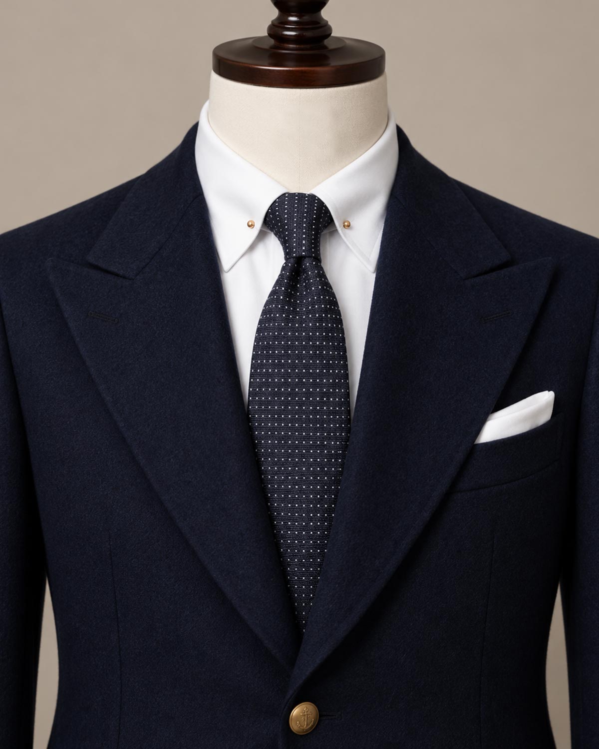 Navy micro-dot silk tie styled on a mannequin with navy suit and white shirt by Stockholm Kravatt