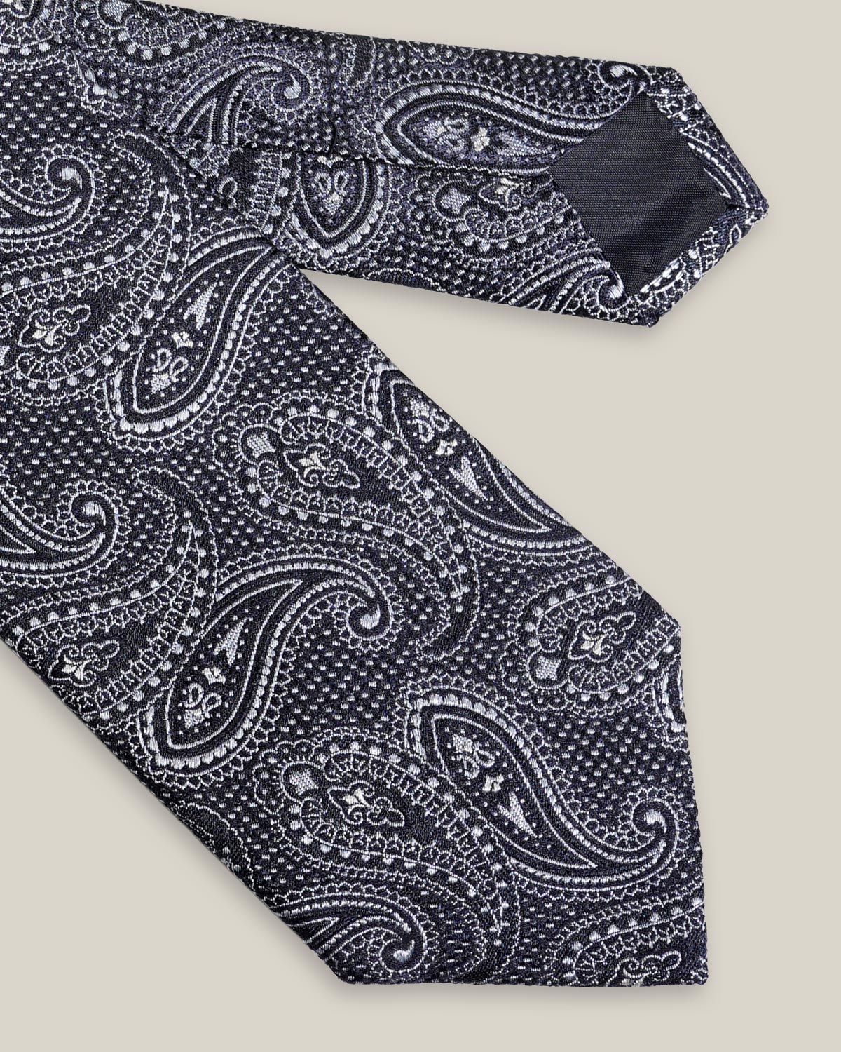 Navy woven silk tie with an intricate all-over silver paisley pattern