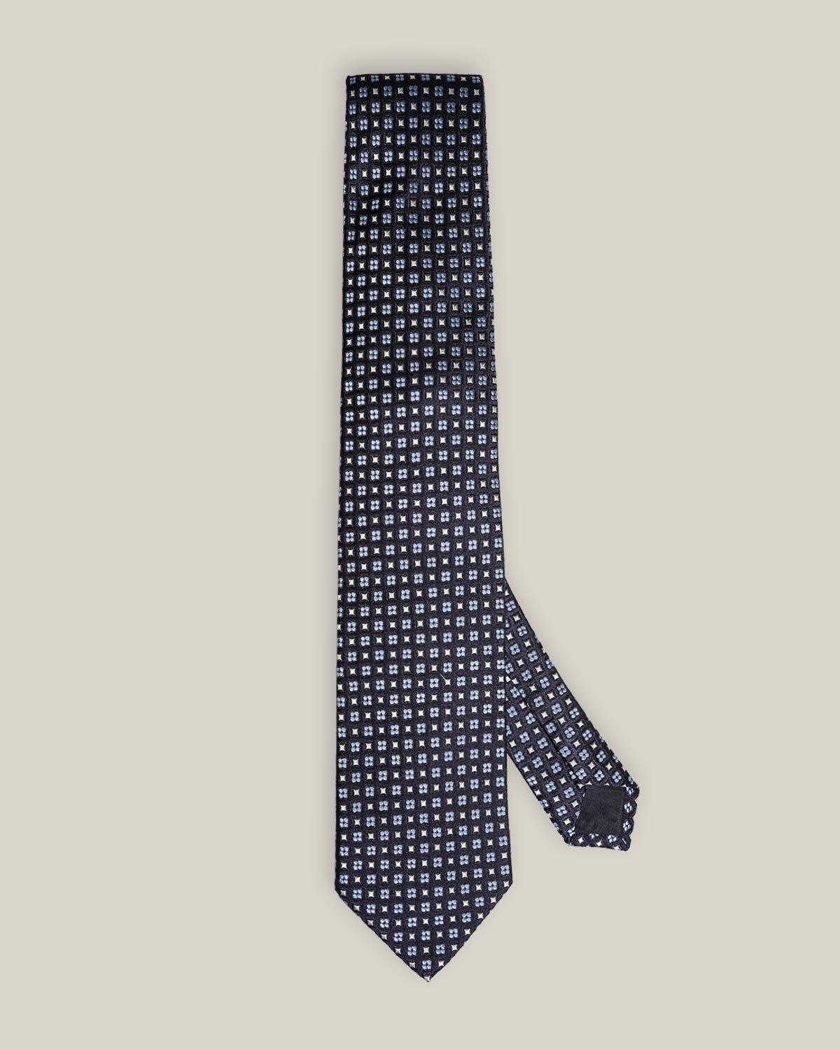 Navy woven silk tie with small light blue floral motifs by Stockholm Kravatt