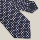 Navy woven silk tie with small light blue floral motifs by Stockholm Kravatt