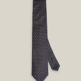 Dark navy woven silk tie with a small silver-toned geometric pattern