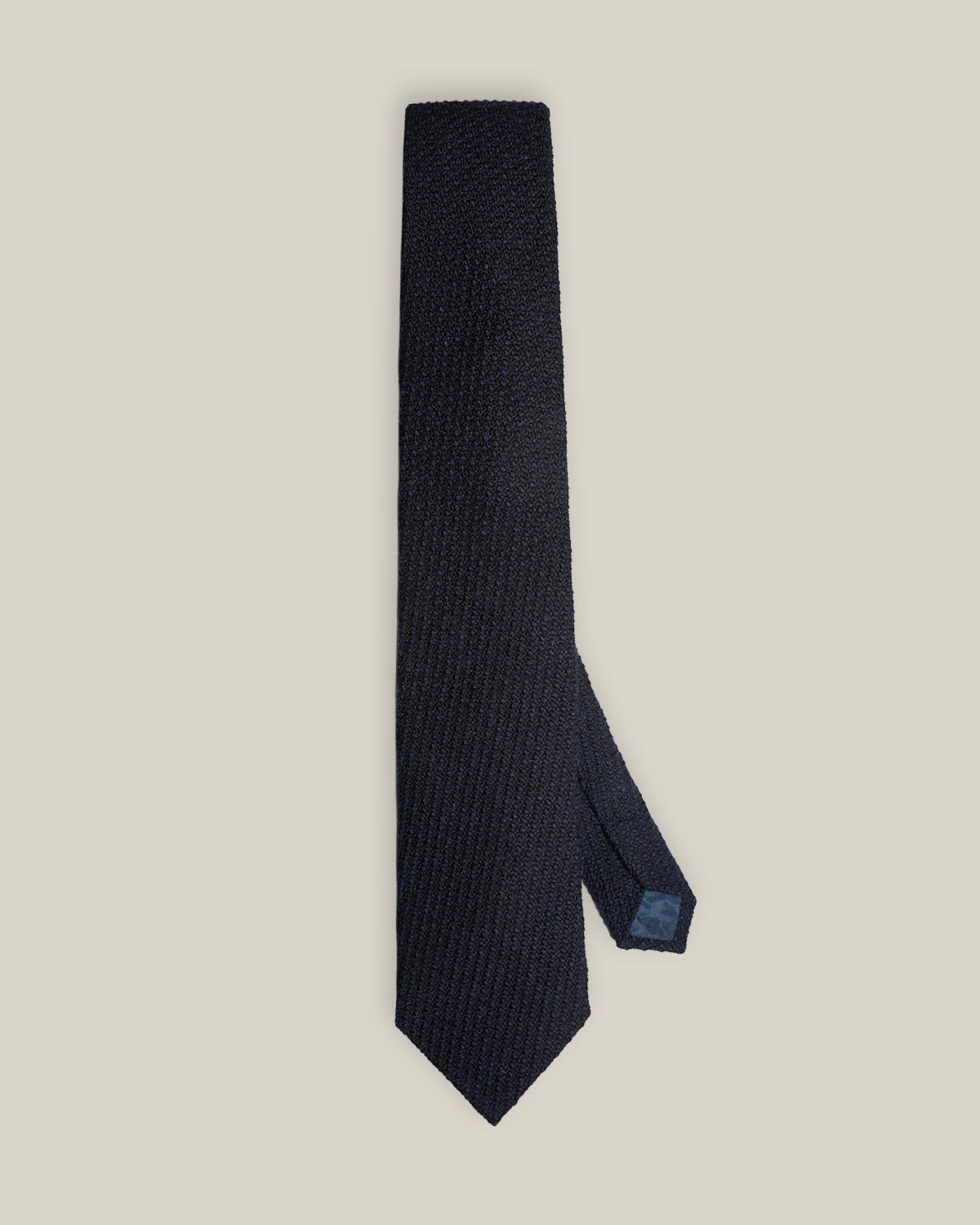 Deep navy woven wool tie with a textured surface and a classic pointed tip.