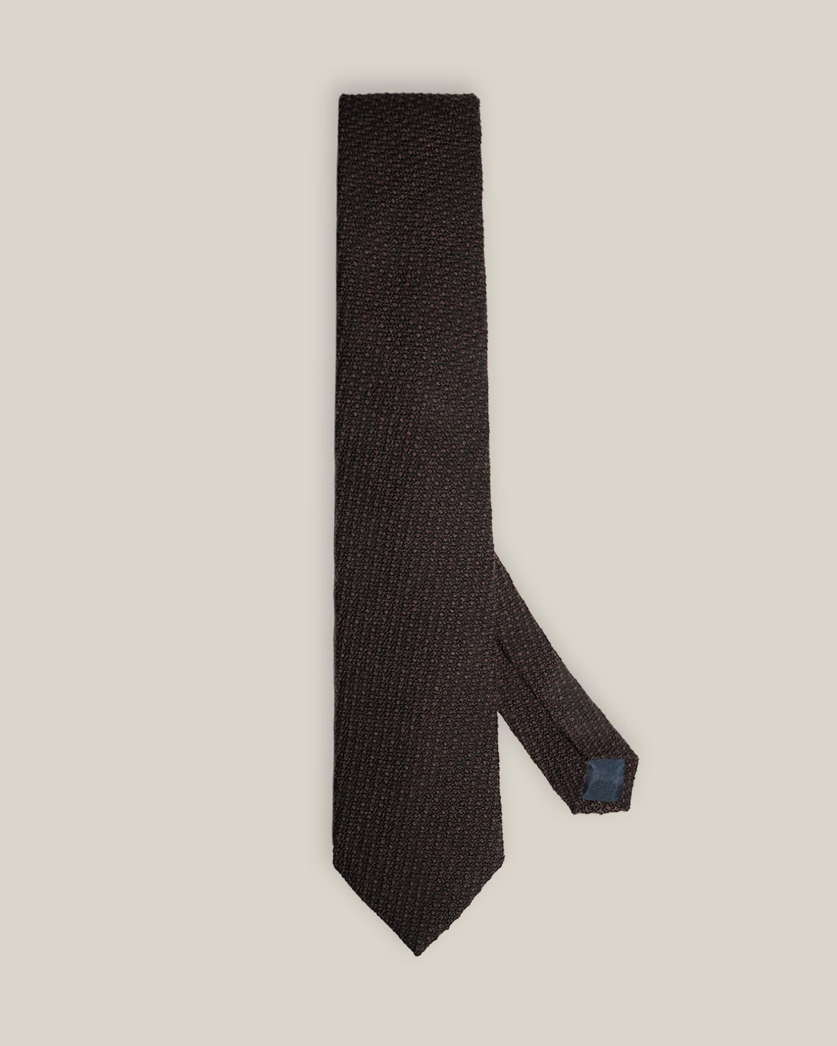 Deep brown woven wool tie with a textured surface and a classic pointed tip.
