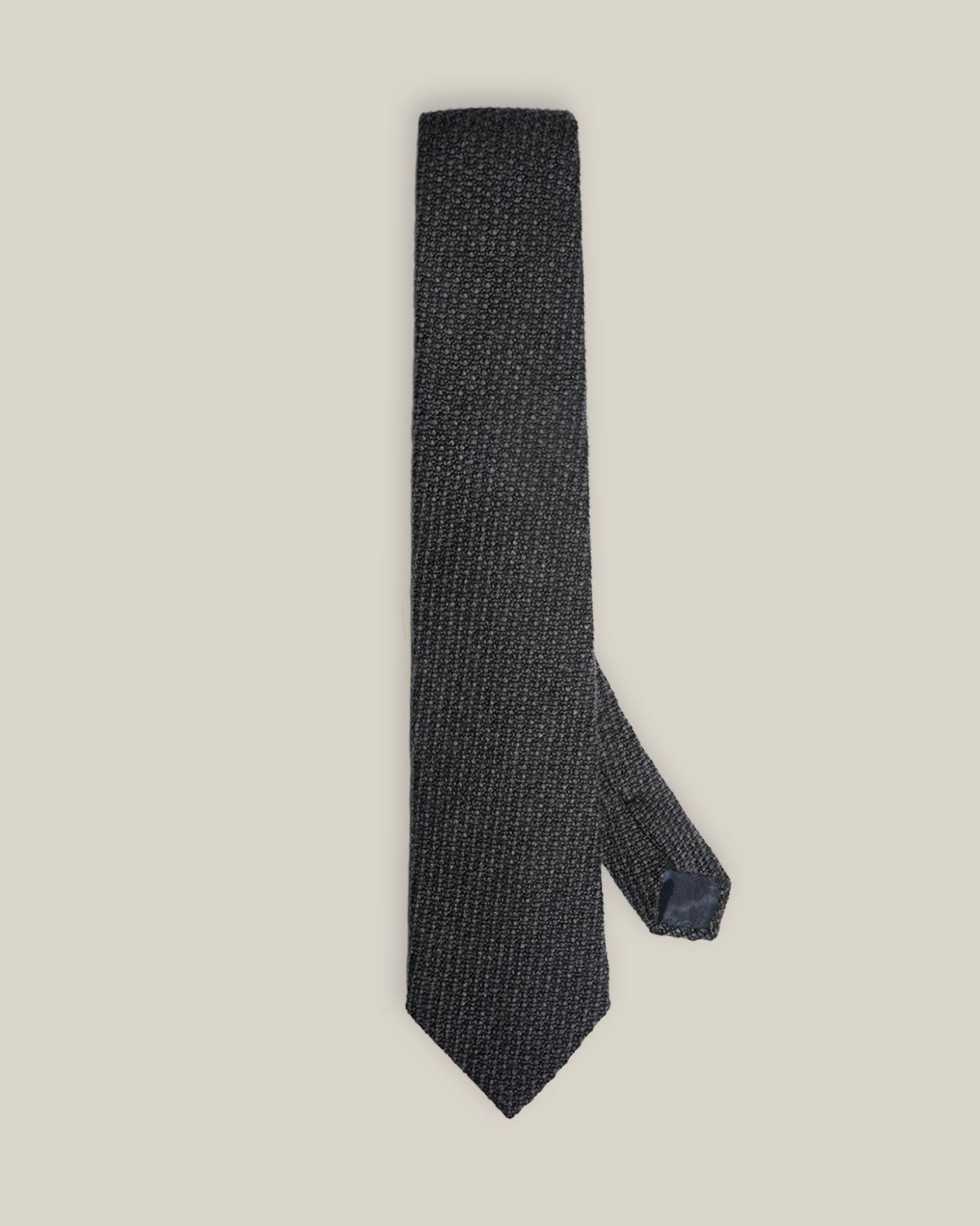Charcoal grey woven wool tie with a textured surface and a classic pointed tip.