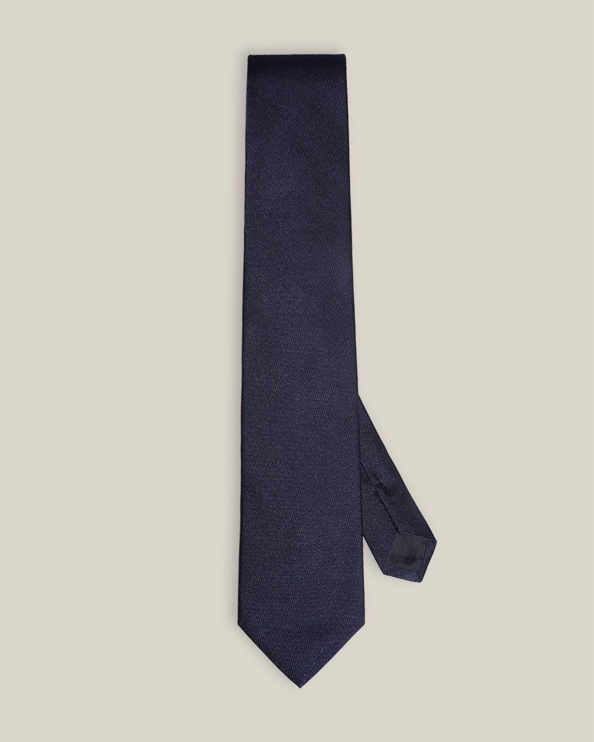 Dark navy woven pure silk tie on a neutral background