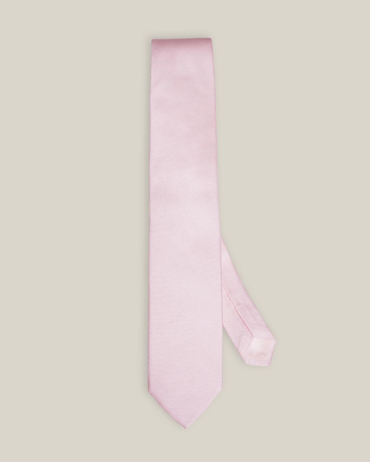 Light pink woven pure silk tie on a neutral background