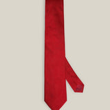 Bright red woven pure silk tie on a neutral background
