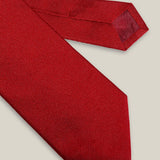 Bright red woven pure silk tie on a neutral background
