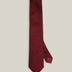 Burgundy woven pure silk tie on a neutral background