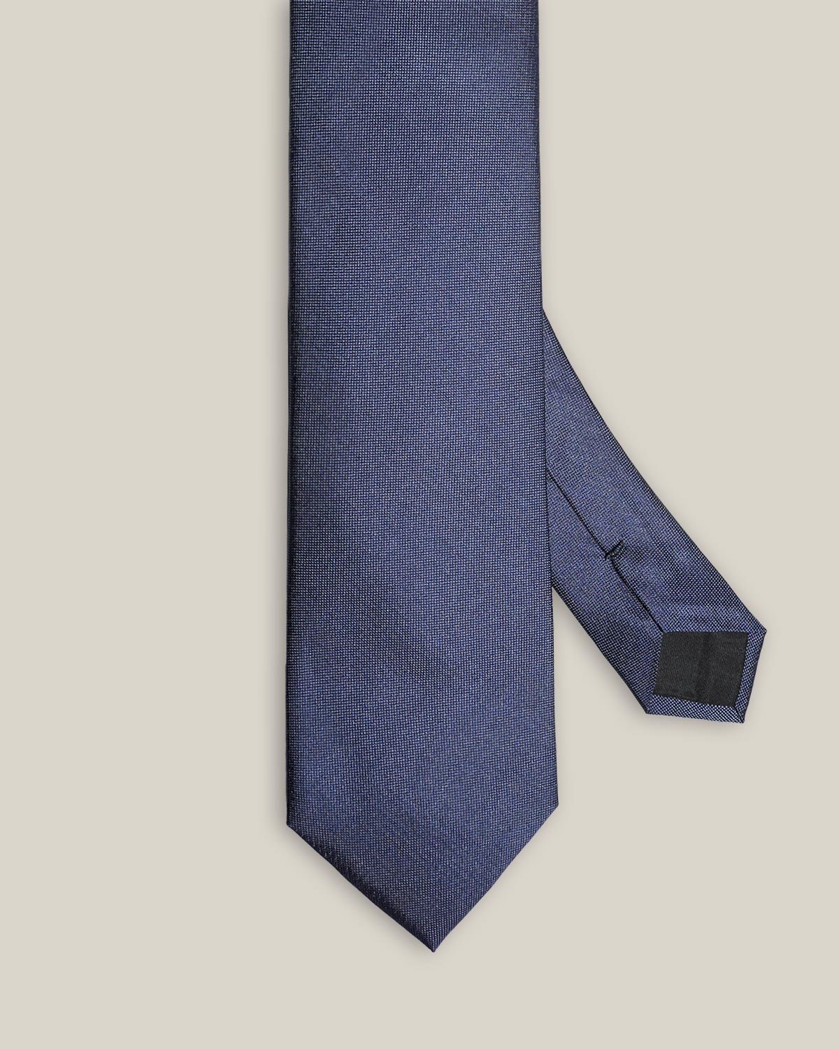 Close-up of blue silk tie showing its fine Oxford weave