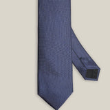 Close-up of blue silk tie showing its fine Oxford weave
