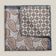 Two sides of a double-face silk pocket square with paisley and geometric patterns