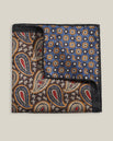 Double-face 100% silk pocket square showing brown paisley on one side and blue geometric floral pattern on the other