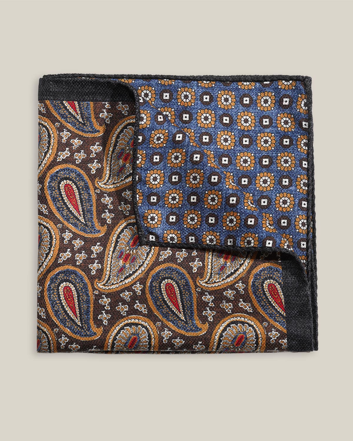 Double-face 100% silk pocket square showing brown paisley on one side and blue geometric floral pattern on the other
